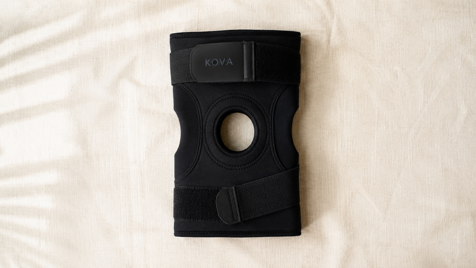 KOVA knee support photographed flat on natural linen